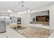 Spacious kitchen features stainless steel appliances, granite countertops, and modern lighting fixtures at 6352 W Maclaurin Dr, Tampa, FL 33647