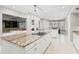 Large kitchen with a spacious island, granite countertops, stainless steel appliances and hardwood floors at 6352 W Maclaurin Dr, Tampa, FL 33647