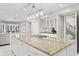 Spacious kitchen featuring a large island, stainless steel appliances, white cabinets and hardwood floors at 6352 W Maclaurin Dr, Tampa, FL 33647