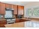 Well-equipped kitchen featuring granite counters, modern appliances, and ample cabinet space at 6352 W Maclaurin Dr, Tampa, FL 33647