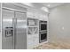 Kitchen features stainless steel appliances, white cabinets, built-in microwave and double oven at 6352 W Maclaurin Dr, Tampa, FL 33647