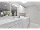 Well-lit laundry room with white cabinets, a sink, and a window providing natural light at 6352 W Maclaurin Dr, Tampa, FL 33647