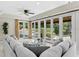 Bright living room with walls of windows overlooking the lush backyard and pool at 6352 W Maclaurin Dr, Tampa, FL 33647