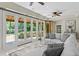 Bright living room with walls of windows overlooking the lush backyard at 6352 W Maclaurin Dr, Tampa, FL 33647