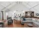 Elegant living room with vaulted ceilings, hardwood floors, and a stylish bar area at 6352 W Maclaurin Dr, Tampa, FL 33647