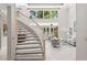 Spacious living area with a staircase, large windows, and neutral color palette at 6352 W Maclaurin Dr, Tampa, FL 33647
