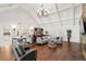 Open-concept living room with vaulted ceilings, hardwood floors, bar area, and lots of seating at 6352 W Maclaurin Dr, Tampa, FL 33647