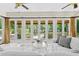 Bright living room with wall to wall windows and doors and stylish decor at 6352 W Maclaurin Dr, Tampa, FL 33647