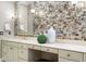 The main bathroom's vanity offers ample storage and counter space with a decorative backsplash at 6352 W Maclaurin Dr, Tampa, FL 33647