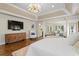 This bright main bedroom features a chandelier, wood floors, and an sitting area at 6352 W Maclaurin Dr, Tampa, FL 33647