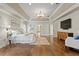 Spacious main bedroom with a tray ceiling, hardwood floors, and an adjacent sitting area at 6352 W Maclaurin Dr, Tampa, FL 33647