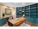 Stylish home office featuring custom teal built-ins, a unique desk, and a cozy reading nook at 6352 W Maclaurin Dr, Tampa, FL 33647