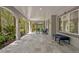 Charming outdoor patio with tiled flooring, comfortable seating, and garden views at 6352 W Maclaurin Dr, Tampa, FL 33647