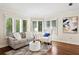 Bright sitting room with hardwood floors, lots of natural light, and stylish decor at 6352 W Maclaurin Dr, Tampa, FL 33647