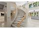 Beautiful curved staircase with wood handrail and carpeting, leading to the upper level at 6352 W Maclaurin Dr, Tampa, FL 33647