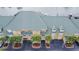 Stunning aerial view of the condo with metal green roof, with boat docks in the waterway behind the units at 6414 Sunset Bay Cir, Apollo Beach, FL 33572