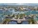 Stunning aerial view of waterfront condos, showcasing the community pool, water features, and serene surroundings at 6414 Sunset Bay Cir, Apollo Beach, FL 33572