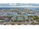 Aerial view of waterfront condos with picturesque canals and boat docks, showcasing luxurious coastal living at 6414 Sunset Bay Cir, Apollo Beach, FL 33572