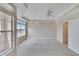 Bright bedroom with large window, neutral paint, carpet, and ceiling fan at 6414 Sunset Bay Cir, Apollo Beach, FL 33572