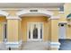 Inviting front entrance with decorative glass door and stately columns at 6414 Sunset Bay Cir, Apollo Beach, FL 33572