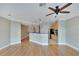 Open living area with hardwood floors flowing into kitchen with breakfast bar at 6414 Sunset Bay Cir, Apollo Beach, FL 33572