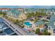 Community pool with a cabana surrounded by lush landscaping in this waterfront condo community with boat docks at 6414 Sunset Bay Cir, Apollo Beach, FL 33572