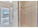 A tile and glass shower with a view through the doorway to the main bedroom at 6414 Sunset Bay Cir, Apollo Beach, FL 33572