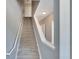 Carpeted staircase with white railings leading to the upper level of the home at 6414 Sunset Bay Cir, Apollo Beach, FL 33572