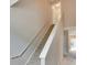 Carpeted staircase with white railing leads to upper level, hallway, and rooms at 6414 Sunset Bay Cir, Apollo Beach, FL 33572