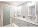 Bathroom featuring double sinks, modern fixtures, and mosaic tile accent wall at 7540 Sunshine Skyway S Ln # 217, St Petersburg, FL 33711