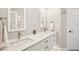 Bathroom with double sinks, sleek white vanity, mosaic tile backsplash, and modern faucets at 7540 Sunshine Skyway S Ln # 217, St Petersburg, FL 33711