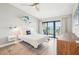 Bedroom featuring a nautical theme, slider to balcony, and wood-look floors at 7540 Sunshine Skyway S Ln # 217, St Petersburg, FL 33711
