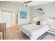 Nautical-themed bedroom with light wood floors, accent wall, and comfortable white bedding at 7540 Sunshine Skyway S Ln # 217, St Petersburg, FL 33711