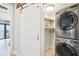 Practical laundry area with stackable washer and dryer and view of water view balcony at 7540 Sunshine Skyway S Ln # 217, St Petersburg, FL 33711