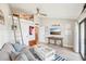 Bright living room featuring a loft ladder and a view of the dining room at 7540 Sunshine Skyway S Ln # 217, St Petersburg, FL 33711