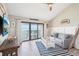 Bright living room featuring a loft ladder and water view balcony at 7540 Sunshine Skyway S Ln # 217, St Petersburg, FL 33711