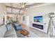 Open-concept living room featuring modern fireplace, stylish decor, and view of dining area at 7540 Sunshine Skyway S Ln # 217, St Petersburg, FL 33711