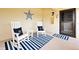 Inviting front porch with rocking chairs, a striped rug, and nautical decor for a coastal vibe at 7540 Sunshine Skyway S Ln # 217, St Petersburg, FL 33711