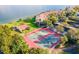 Aerial view of community tennis courts, adjacent to water and condos at 7540 Sunshine Skyway S Ln # 217, St Petersburg, FL 33711