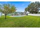 The home's backyard has a pool, a screened in patio, and a spacious lawn for outdoor fun at 7690 91St St, Seminole, FL 33777
