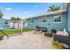 Backyard featuring an outdoor seating area with a fire pit and a hammock at 7690 91St St, Seminole, FL 33777