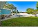 Backyard featuring a patio with a fire pit, a hammock, and green grass at 7690 91St St, Seminole, FL 33777