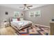 Bright bedroom with a large bed, colorful rug, and shuttered windows at 7690 91St St, Seminole, FL 33777