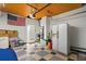 The garage has a checkered floor and wood plank ceiling, plus storage and a doorway to the home at 7690 91St St, Seminole, FL 33777