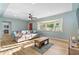Cozy living room featuring hardwood floors, a ceiling fan and a large sofa at 7690 91St St, Seminole, FL 33777