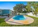 Backyard view of a refreshing kidney-shaped pool, a relaxing hammock, and screened in lanai at 7690 91St St, Seminole, FL 33777