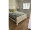 Bedroom featuring a queen bed, white furniture, and hardwood floors at 8320 112Th St # 206, Seminole, FL 33772