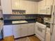 Kitchen with white cabinets, blue countertops, and updated appliances at 8320 112Th St # 206, Seminole, FL 33772