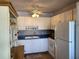 Kitchen with white cabinets, blue countertops, and updated appliances at 8320 112Th St # 206, Seminole, FL 33772