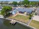 Aerial of backyard with dock, screened lanai, gazebo and shed on canal in Bay Crest Park at 8702 Driftwood Dr, Tampa, FL 33615